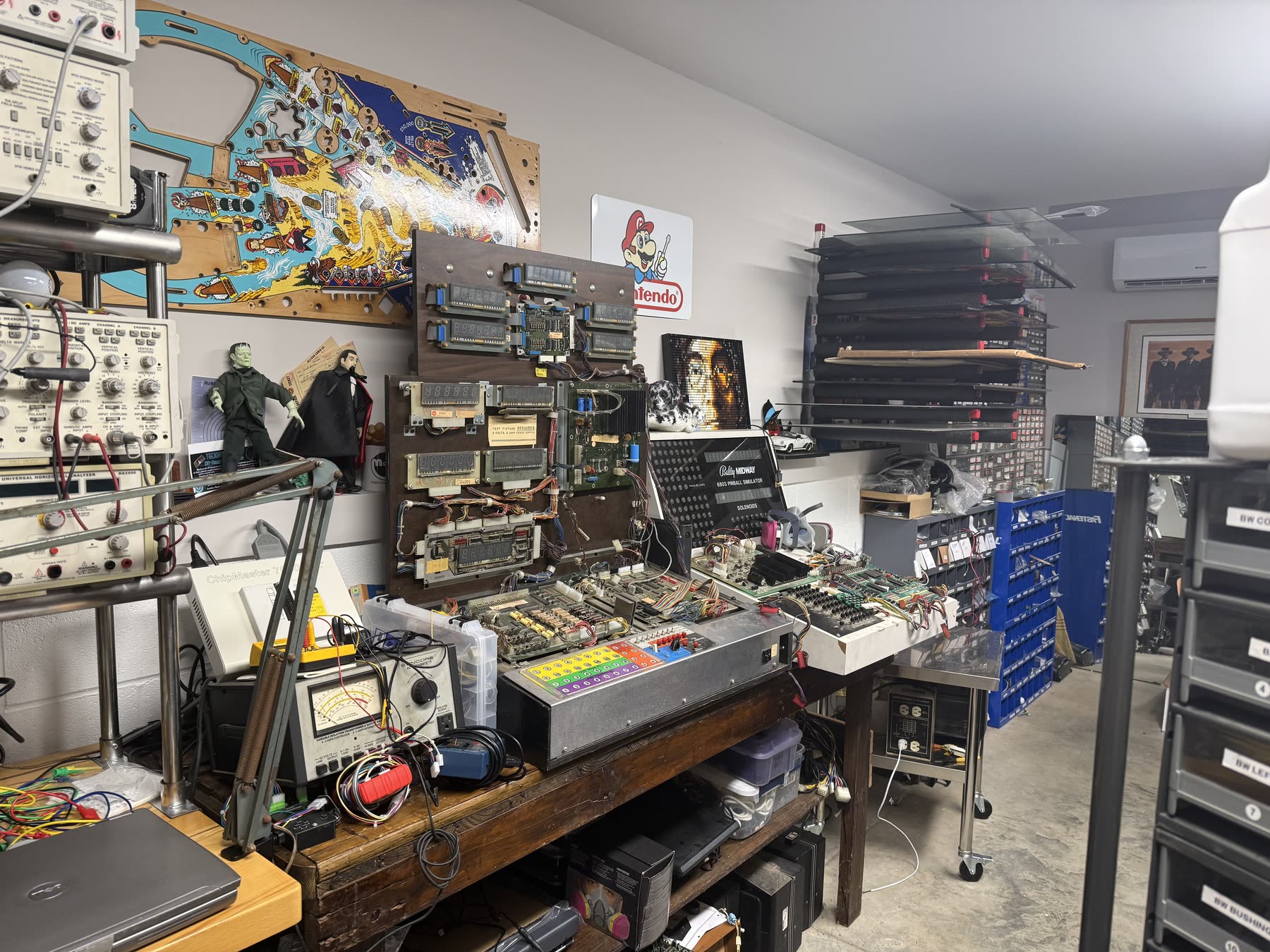 Pinball circuit boards, test fixtures, and electronic diagnostic equipment in the Carolina Pinball Repair workshop